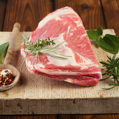 Raw,Shoulder,Lamb,On,Wooden,Board,And,Table